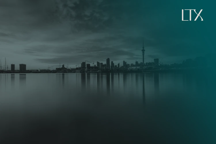 The Auckland skyline and Sky Tower at dusk across calm water, with the LTX logo at the top right.